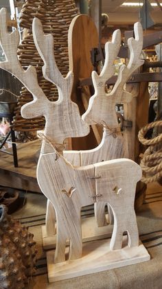 two wooden reindeer sculptures sitting on top of a table