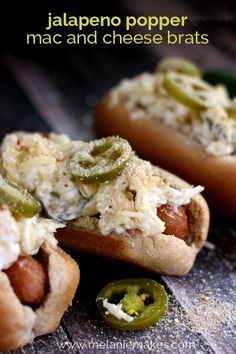 two hot dogs covered in cheese and pickles