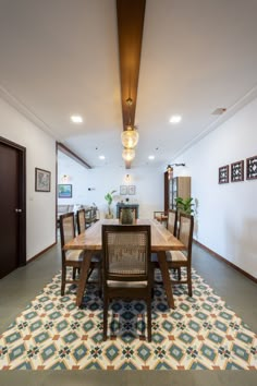 the dining room table is surrounded by chairs and rugs with an intricate pattern on it