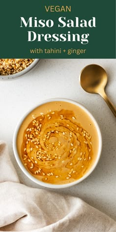 a white bowl filled with sesame seeds next to a spoon and some other food items