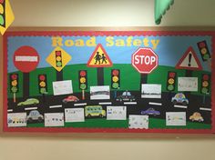 a road safety bulletin board with cars and stop signs