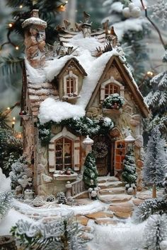 a christmas scene with a small house in the snow