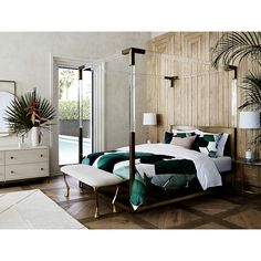 a bed room with a neatly made bed next to a window and a palm tree