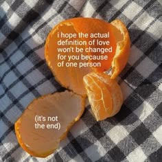 an orange that has been cut in half on a checkered table cloth with the words, i hope the actual definition of love won't be changed for you because of one person