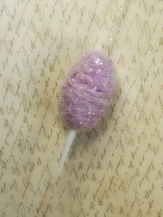 a purple lollipop sitting on top of a table