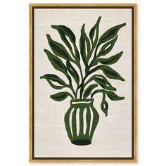 a green vase filled with lots of leaves on top of a white wall mounted art piece