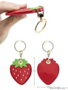 the strawberry shaped keychain is attached to a pair of red leatherettes