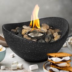 a bowl filled with marshmallows and fire