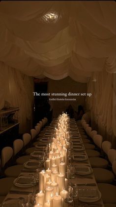 a long table with many lit candles on it and the words, the most stunning dinner set up