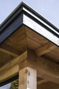 the top of a wooden structure with metal roof