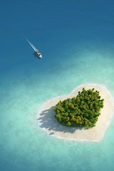 an island in the shape of a heart with a boat floating on it's side