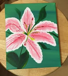 a painting of a pink flower on a green background