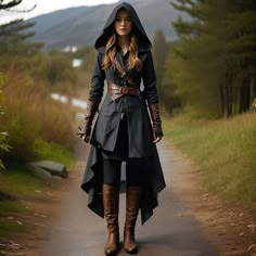 a woman is walking down a path wearing a hoodie and boots with her hands in her pockets