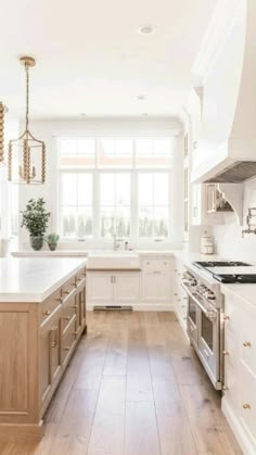 a kitchen with white cabinets and wooden floors is shown on the phone screen, showing an open window