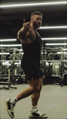 a man standing on top of a skateboard in a room filled with gym equipment