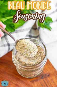 a spoon full of seasoning sitting on top of a wooden cutting board