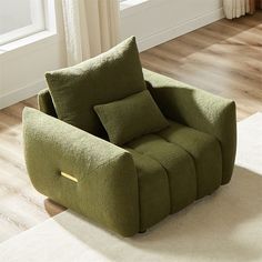 a green recliner chair sitting on top of a wooden floor next to a window