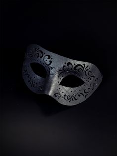 Black vegan leather masquerade mask with an engraved design. Veil Mask Men, Cheap Black Themed Masks, Black Elegant Mask, Luxury Artistic Black Mask, Black Luxury Eye Mask For Masquerade, Luxury Black Eye Mask For Masquerade, Luxury Black Party Masks, Luxury Black Theater Masks, Bird Mask Black