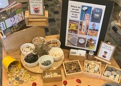 an assortment of rocks and magnets on a wooden table with a black board in the background