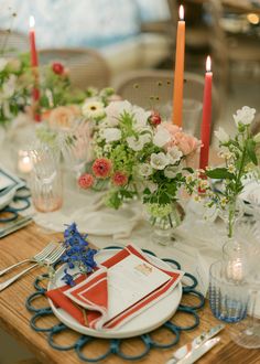 the table is set with flowers, candles and place settings for dinner guests to enjoy