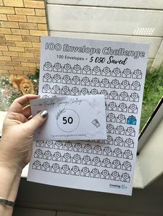 someone is holding up a 50 envelope with the number fifty and an image of a dog on it