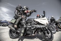 two men in full leather gear on motorcycles