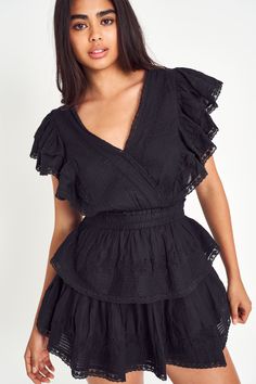 Our Gwen Dress is a sure favorite in cotton with lace embroidery details. This short frock has a faux wrap top, which forms a deep v neckline. Shirred ruffles line the outer edges of the shoulder and bodice, forming flutter sleeves. The skirt is constructed just like our signature Ruffle Miniwith an elastic waist and two flounced tiers.*Due to the nature of the hand dye process, colors may vary from what is pictured. Short Frock, Faux Wrap Top, Exclusive Clothing, Ruffle Mini Dress, Dyed Dress, Lace Embroidery, Black Ruffle, Embroidery Details, New Arrival Dress