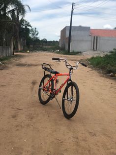 a bike parked on the side of a dirt road