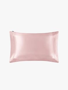 an image of a pink satin pillow on a white background with copy space for text