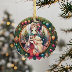 a christmas ornament with a woman holding a cat in front of a tree