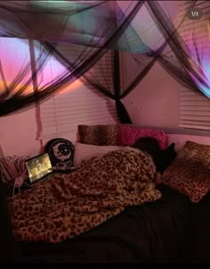 a bed with leopard print sheets and pillows