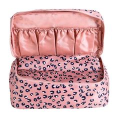 an open pink leopard print suitcase on a white background