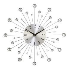 a silver clock with lots of crystal balls on it's face and numbers in the middle