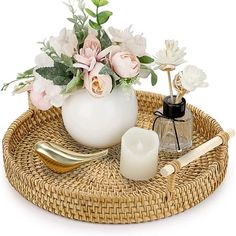 a wicker tray with flowers and candles on it