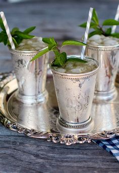 three mint - filled bourbon and mint sugar shakers on a silver tray with text overlay