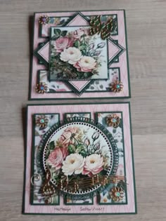 two cards with flowers on them sitting on top of a wooden table next to each other