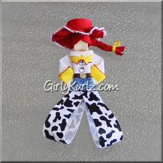 the doll is wearing a red hat and white shirt with black spots on it's legs