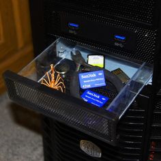 the inside of a computer case with various items in it and on top of each other