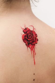 a woman with a rose tattoo on her back