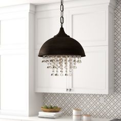 a chandelier hanging from the ceiling in a kitchen