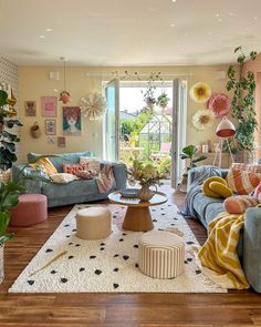 a living room filled with furniture and lots of plants