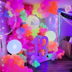 balloons and streamers decorate the entrance to a 13th birthday party