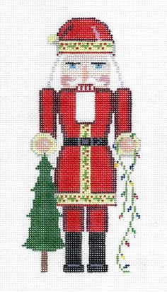 a cross stitch pattern of a santa clause holding a christmas tree and wearing a red suit