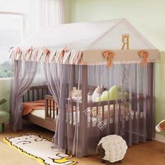 a child's bedroom with a canopy bed and sheep rug