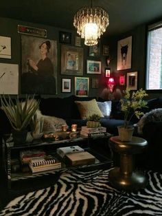 a living room filled with lots of furniture and pictures on the wall next to a window