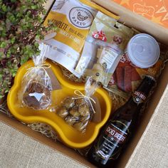 an open box containing coffee, nuts and other items for a dog's treat