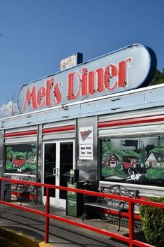 the entrance to a diner with red railings