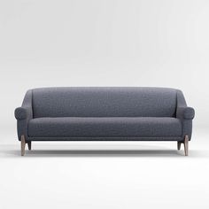 a gray couch with wooden legs on a white background