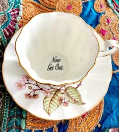 a tea cup and saucer sitting on top of a table