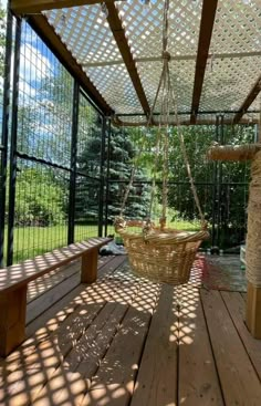 a wooden deck with a hanging basket on it